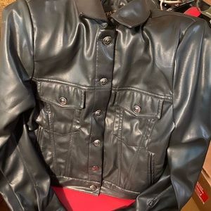 Collared Long sleeve. Front chest pockets and bottom cuff. Faux leather fabric.